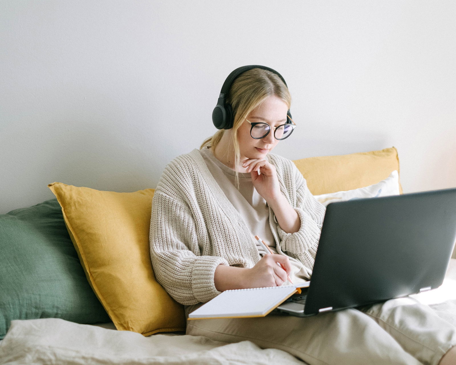 Girl texting on her phone in front of a computer